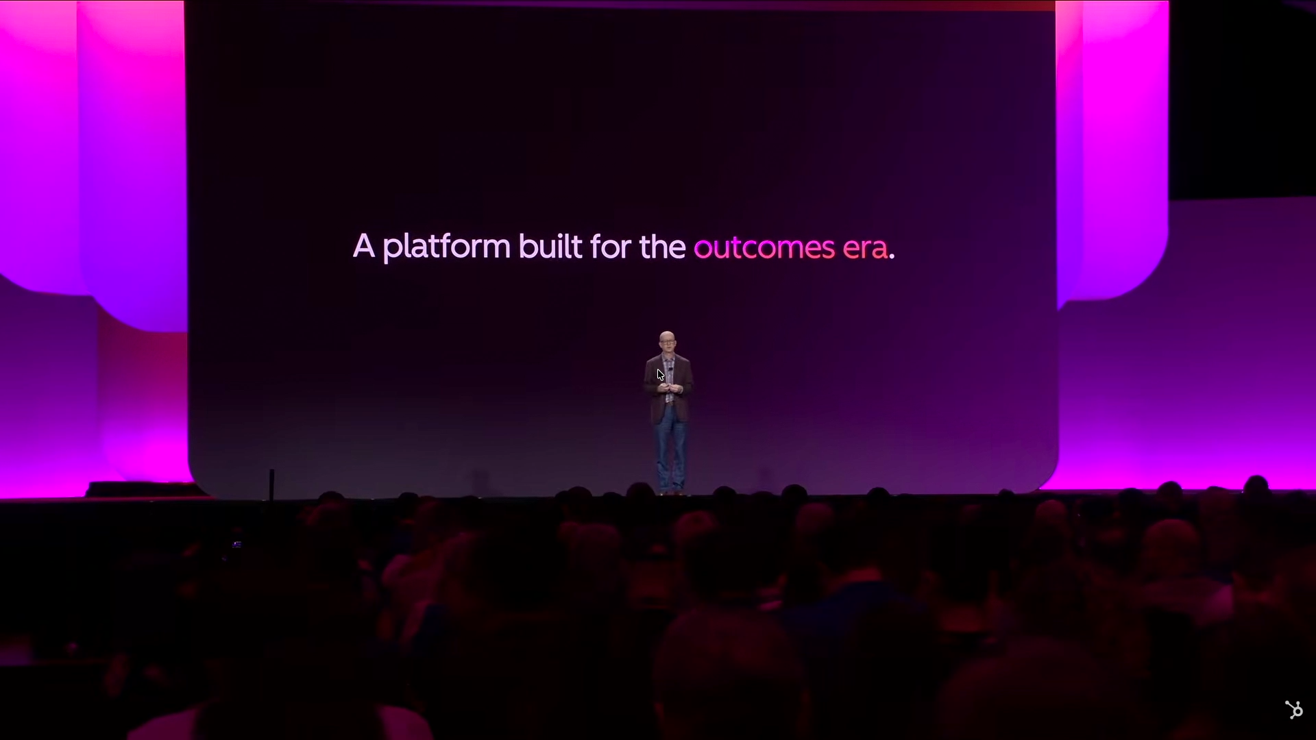 Stage screen showing the words A platform built for, with the presenter in front of the display